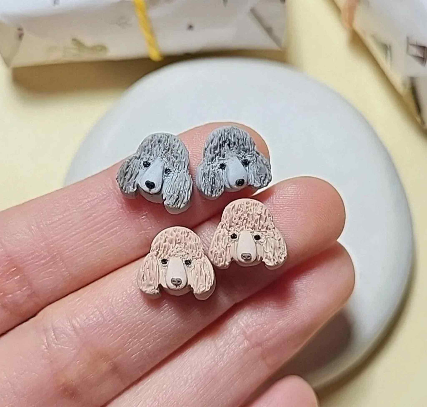 Cute Poodle stud earrings in gray, brown, white and black colors.