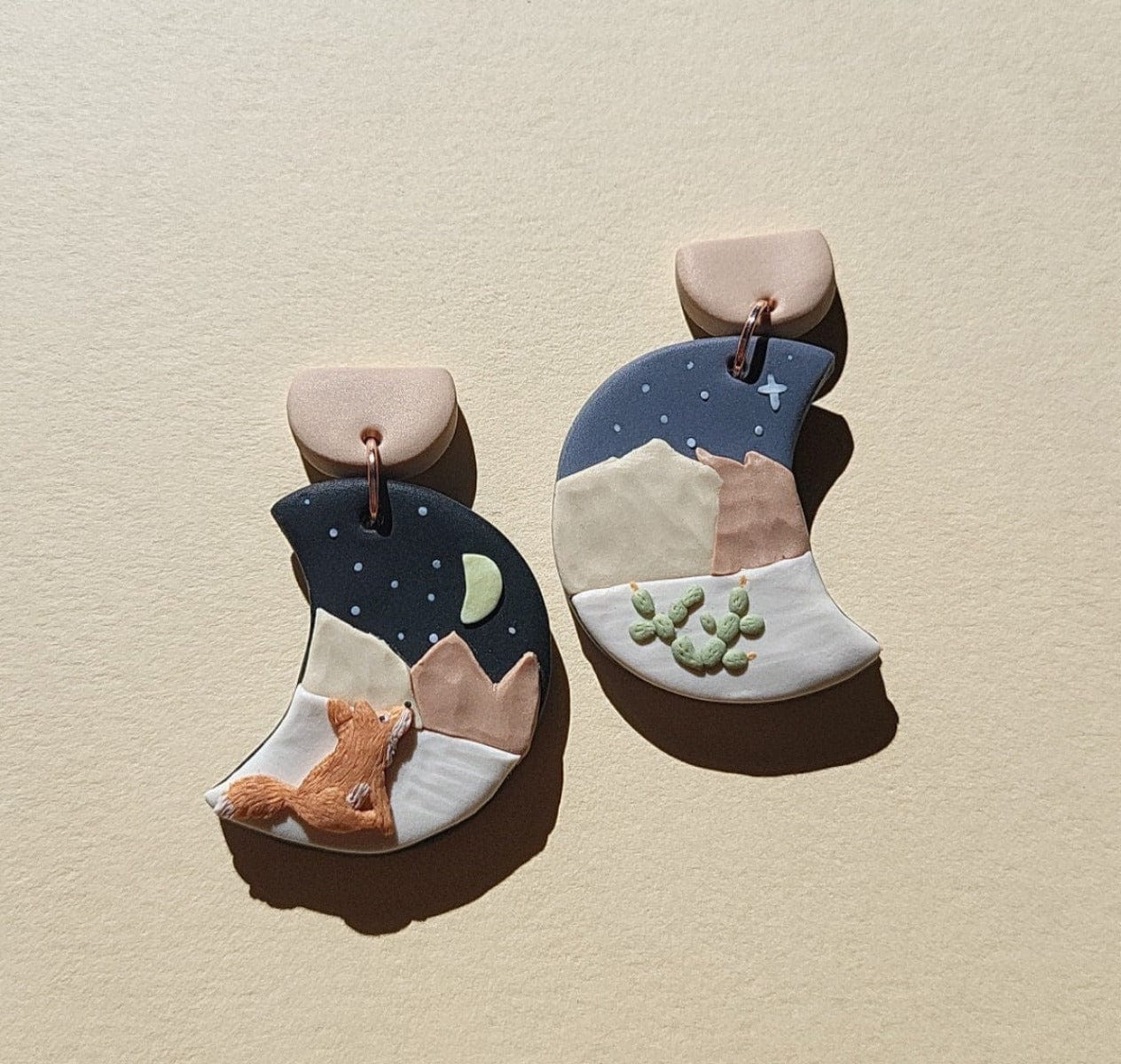 Mismatched landscape earrings with red fox in desert mountain