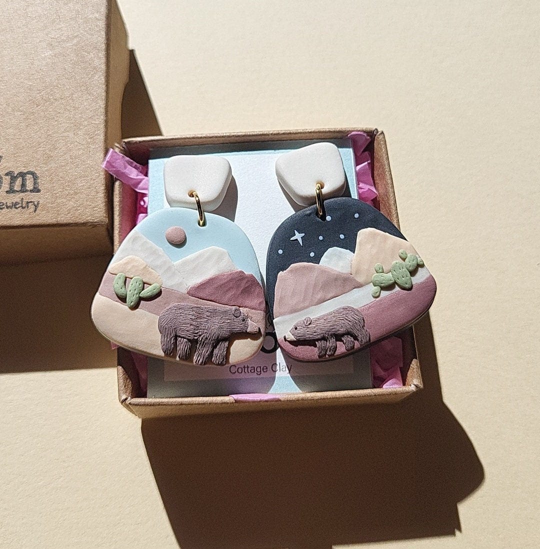 Mismatched desert mountain earrings with brown bear