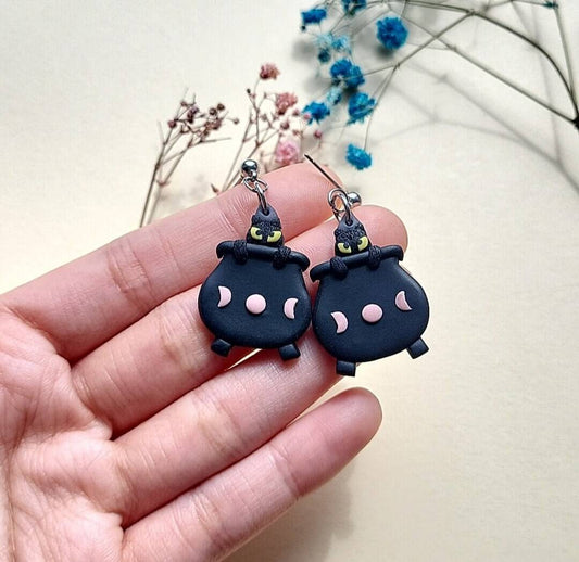 Halloween cat earrings in cauldron. 