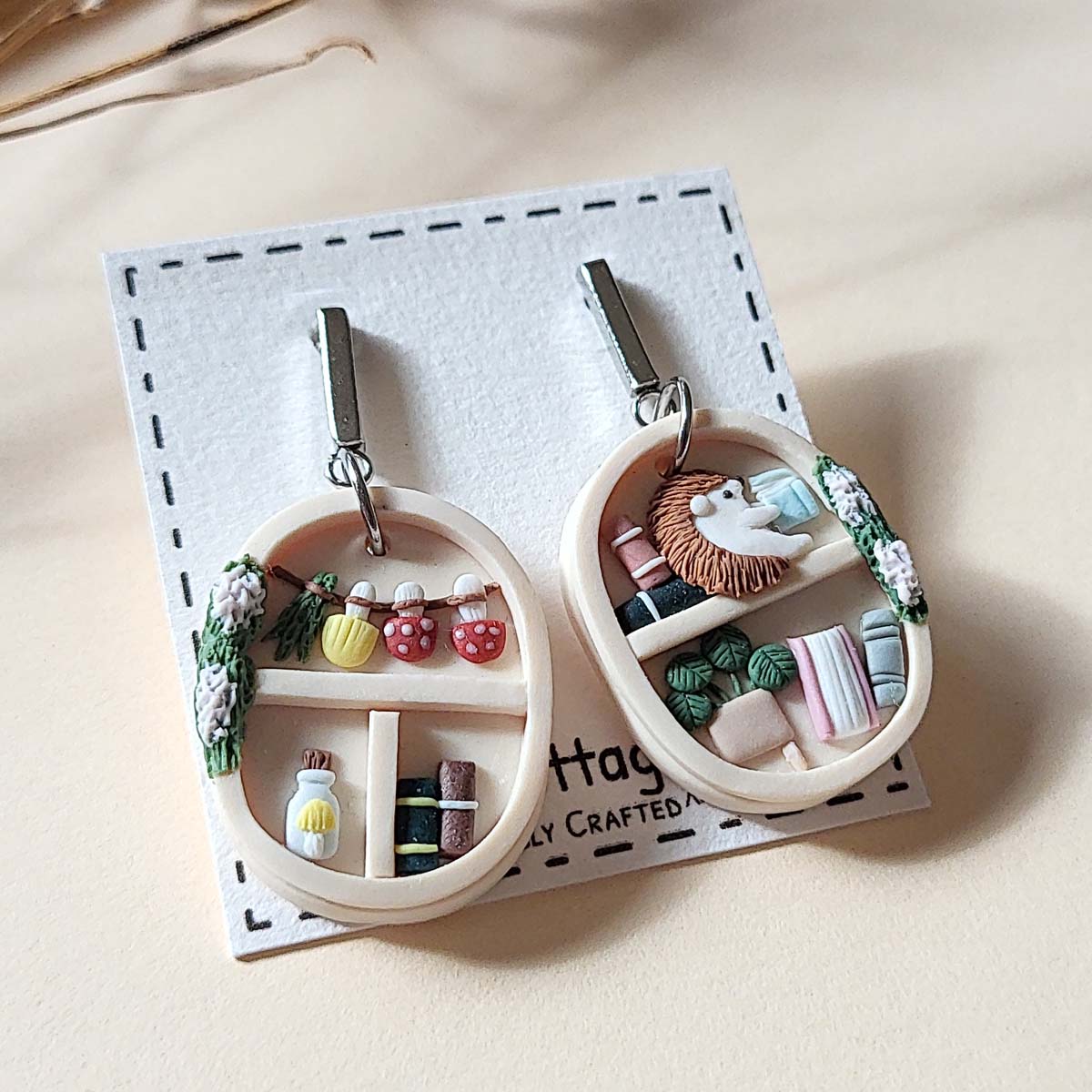 Handmade cottagecore bookshelf  and plant polymer clay earrings with hedgehog