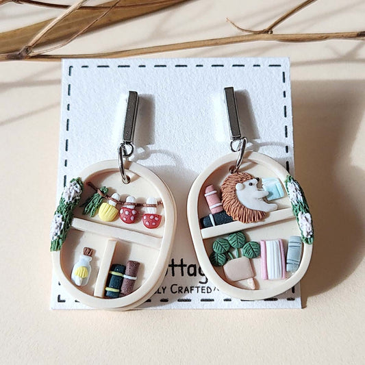 Handmade whimsical bookshelf  and plant polymer clay earrings with hedgehog