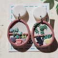 Cottagecore plant shelf earrings with black cat