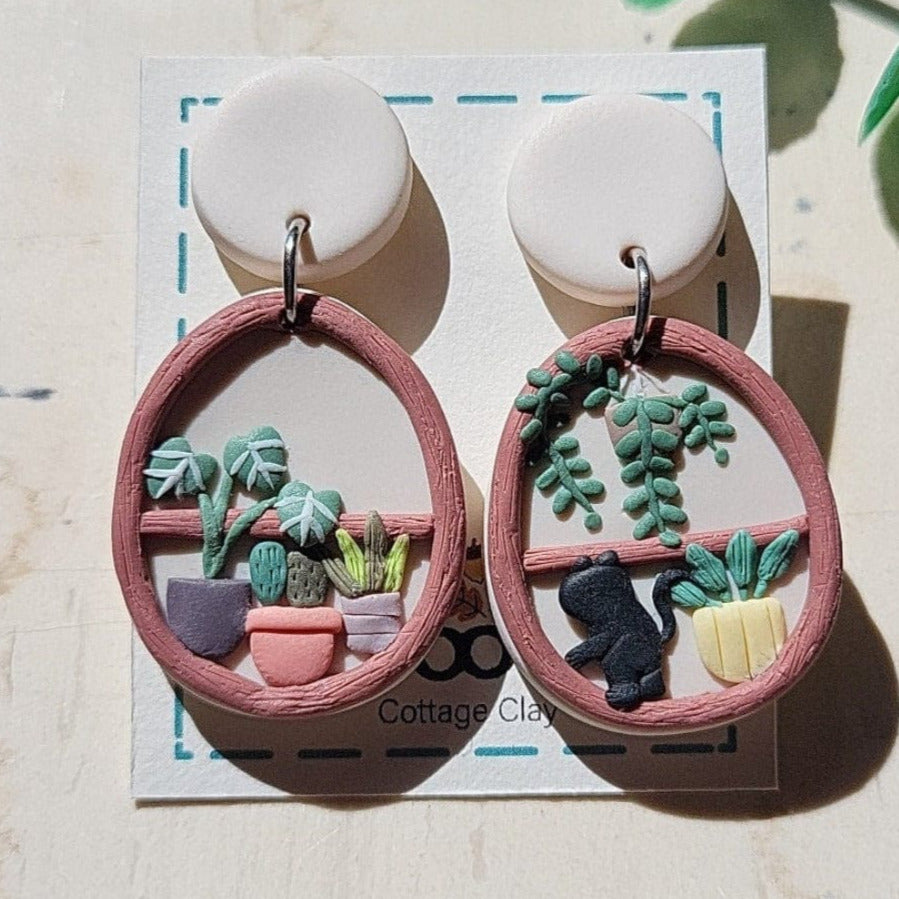 Cottagecore plant shelf earrings with black cat