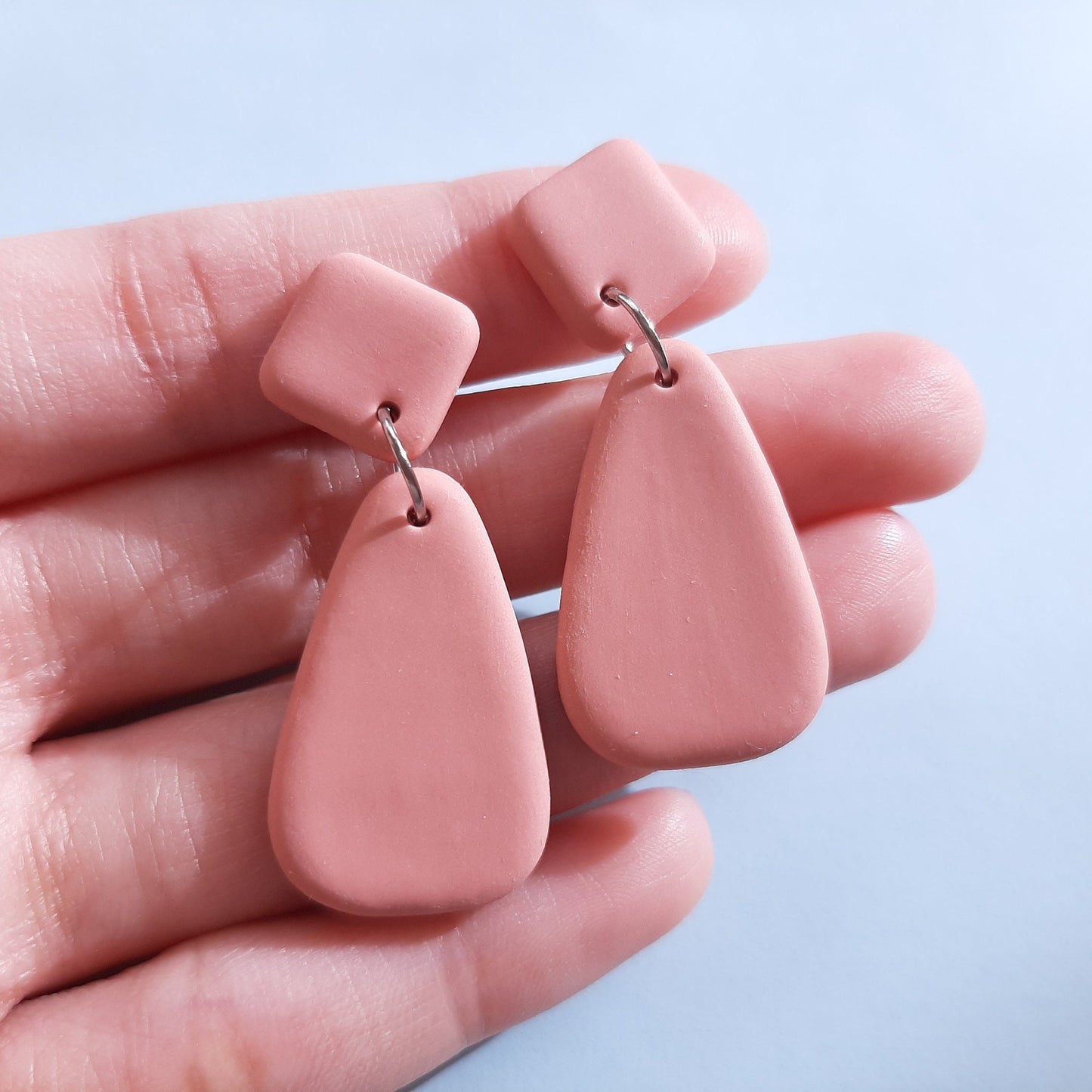 minimalist pink clay earrings in triangle shape