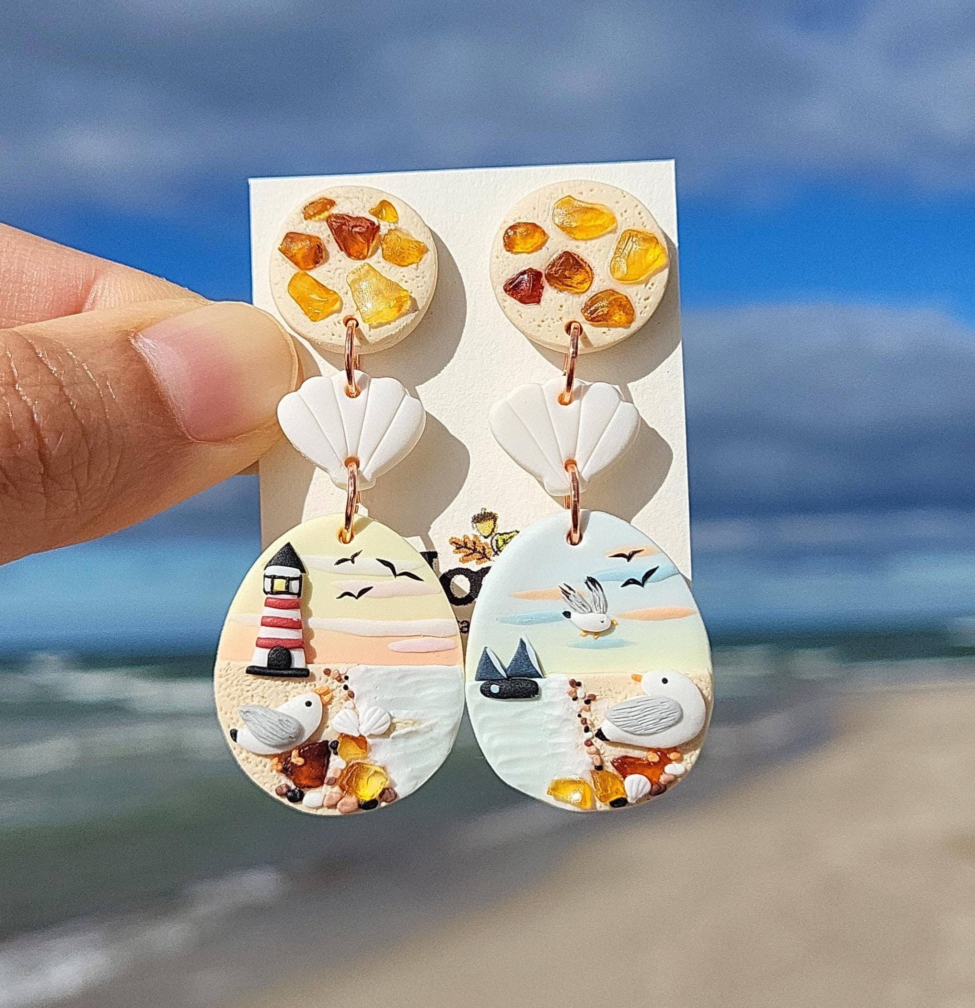 Dangle and drop ocean earrings with seagull and natural amber stone. Handmade from polymer clay with surgical stainless steel ear posts & backings. They are unique and cute gifts for women.