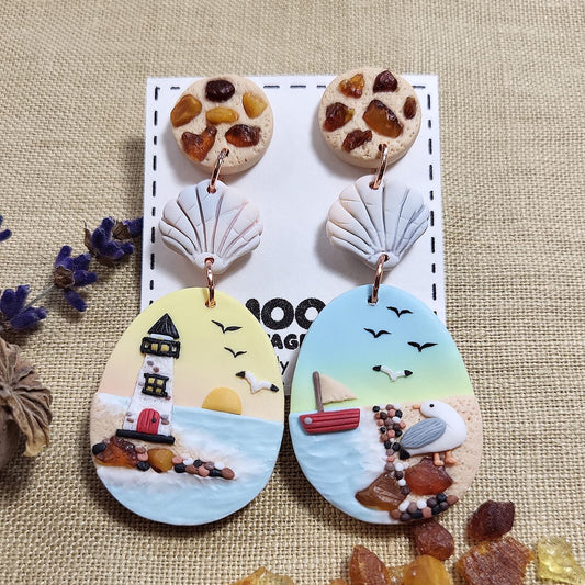 Handmade dangle ocean seagull earrings with natural amber stone. Rankų darbo auskarai su jūra, gintaru ir kiru