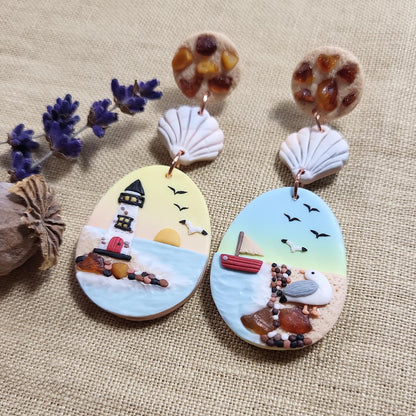 Handmade dangle ocean seagull earrings with natural amber stone. Rankų darbo auskarai su jūra, gintaru ir kiru