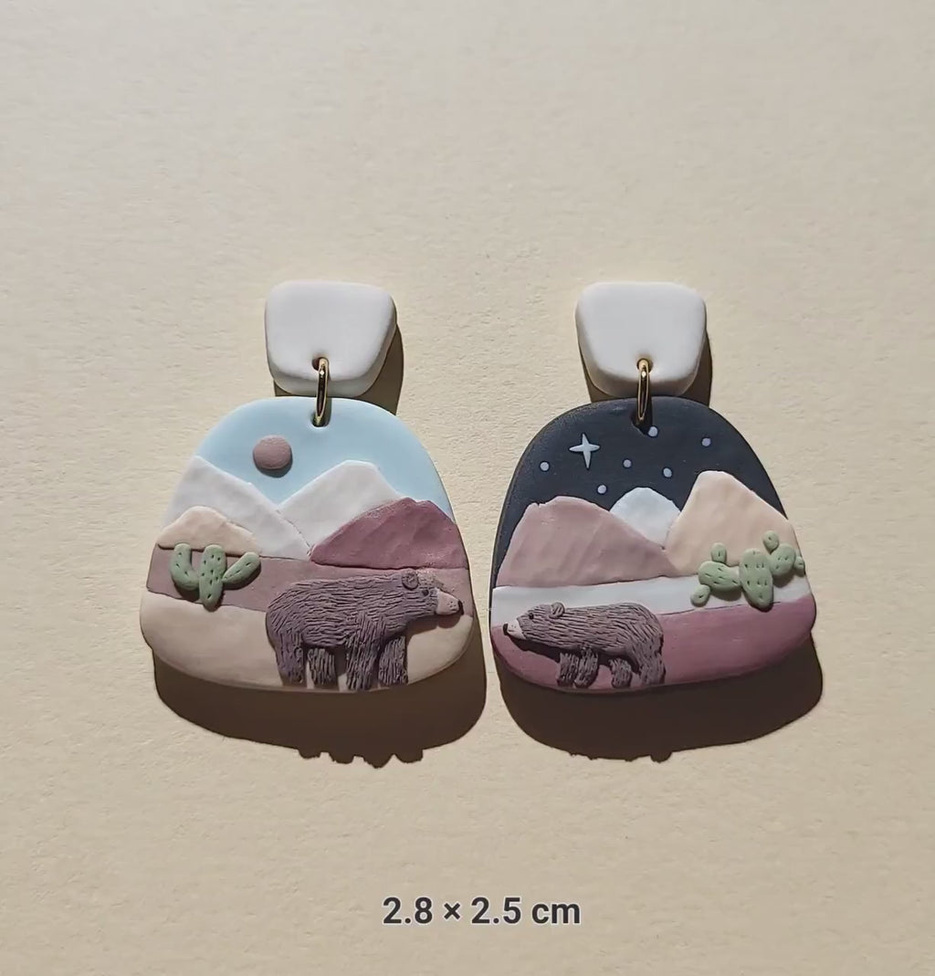 Cute mismatched grizzly bear earrings in desert 