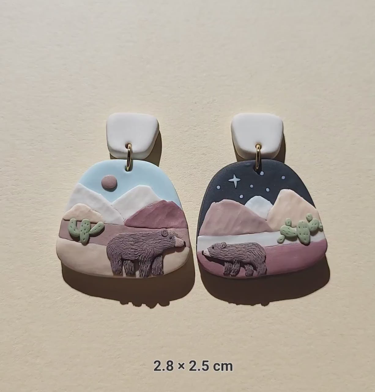 Cute mismatched grizzly bear earrings in desert 