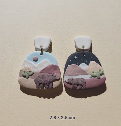 Cute mismatched grizzly bear earrings in desert 