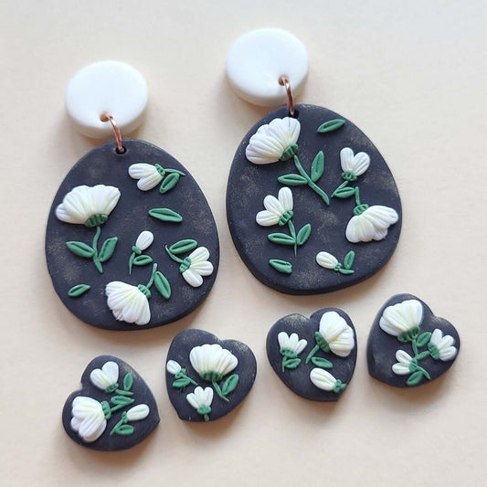 Polymer clay while flower earrings with black base